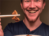 A happy individual enjoying a plate of low-carb Chinese food, symbolizing the harmony of taste